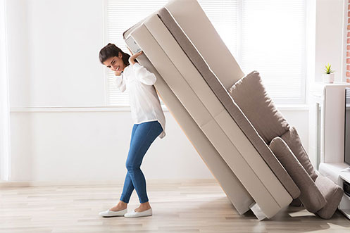 Woman moving sofa | Concept Flooring