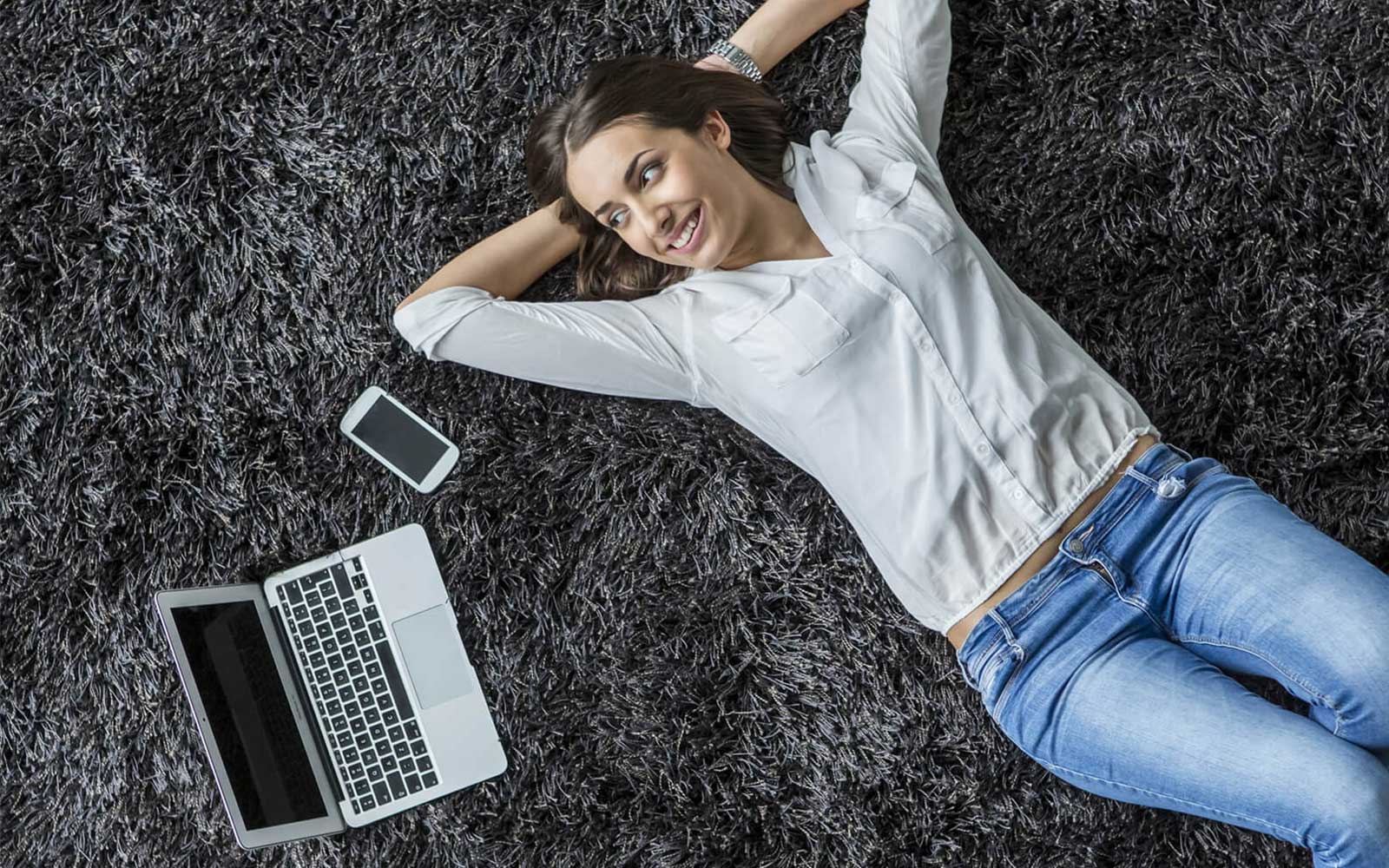 Woman lying on carpet flooring | Concept Flooring
